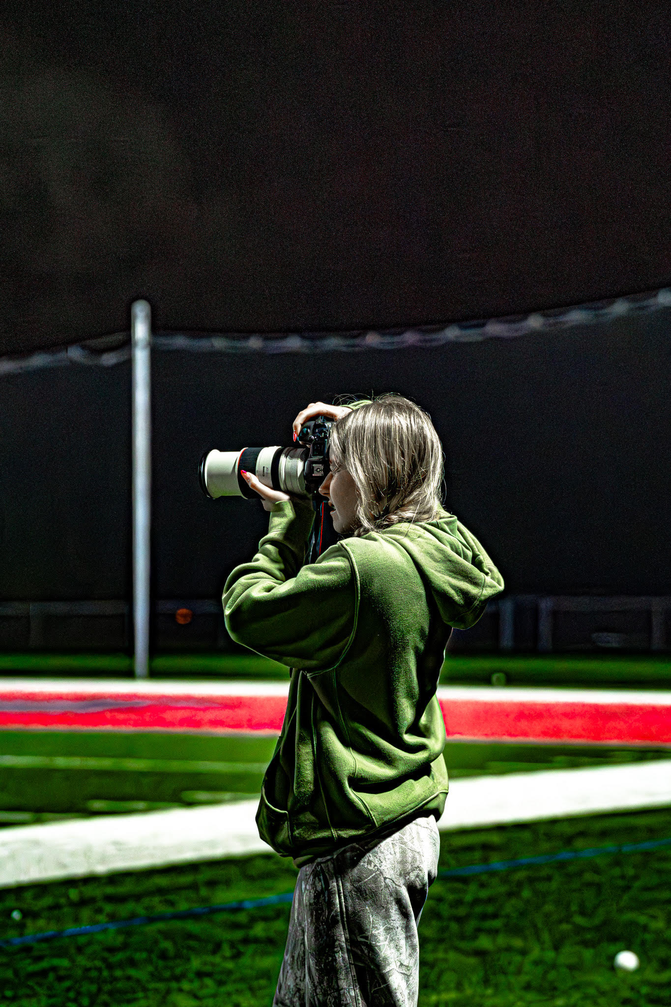 Ashlyn photographing from the sideline